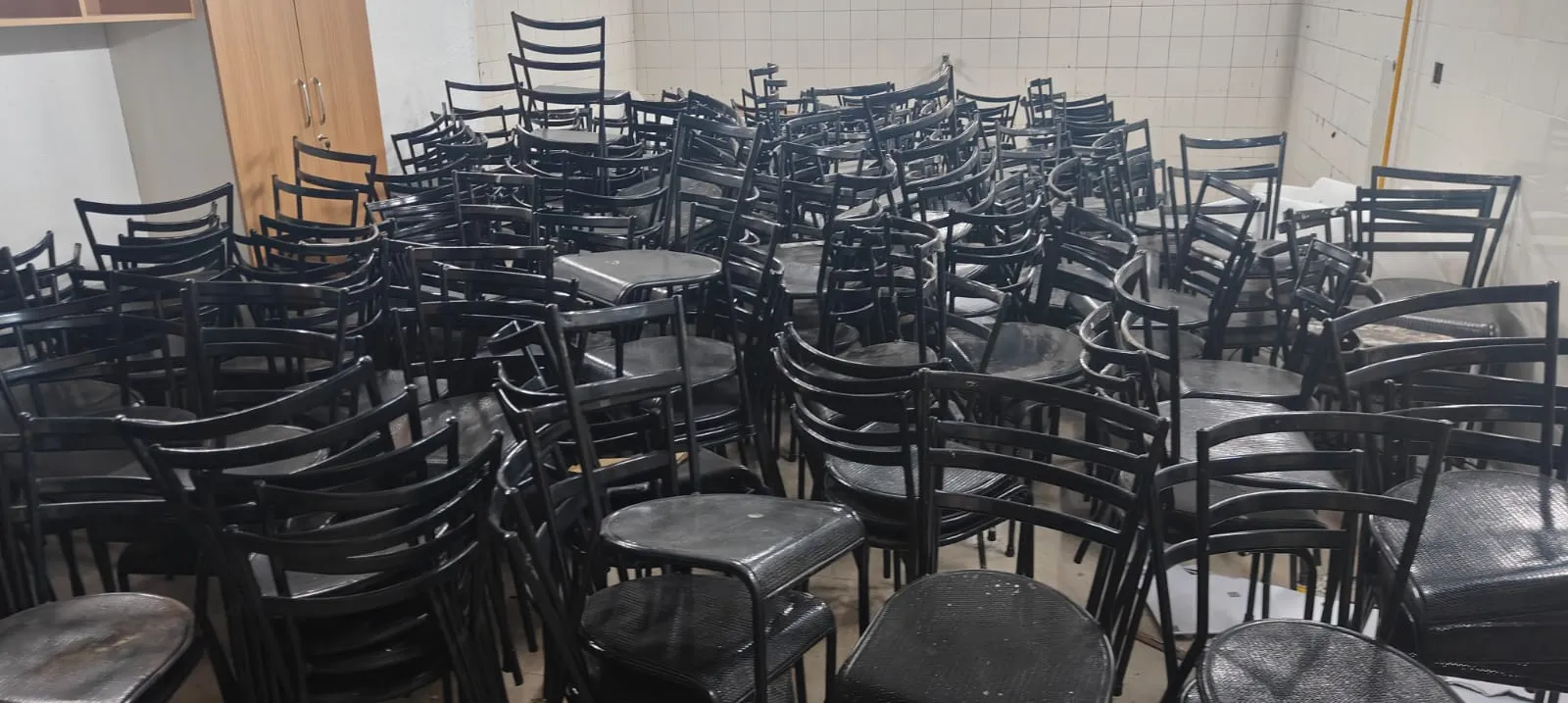 Bulk office furniture clearance Bangalore — stacked workstations and office chairs loaded for corporate furniture disposal