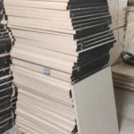 Systematically stacked wooden partition boards and ceiling panels collected for debris removal in Bangalore